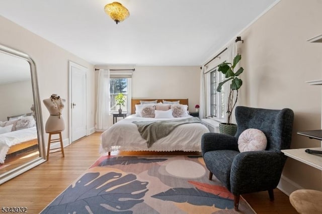 bedroom featuring baseboards and wood finished floors