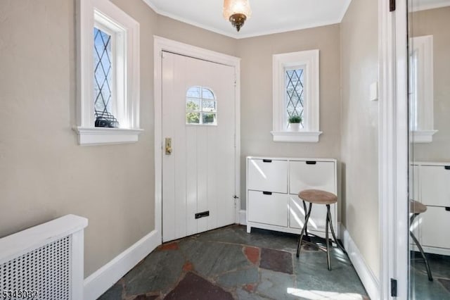 entrance foyer featuring baseboards and ornamental molding