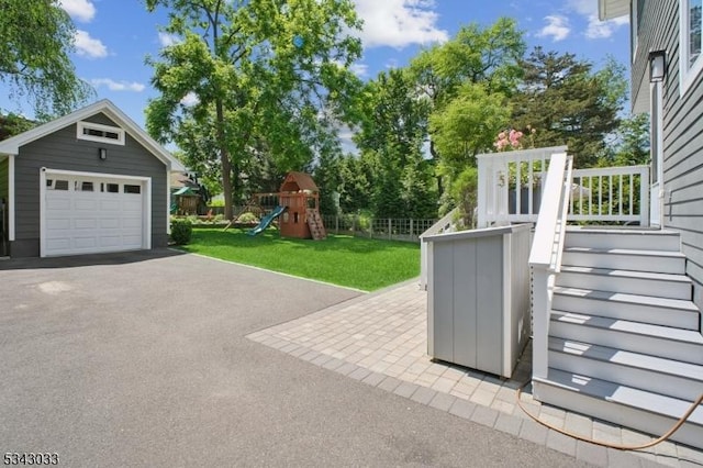 22 Salter Pl, Maplewood Twp, NJ 07040 - view of patio with an outbuilding, a detached garage, a playground, and asphalt driveway