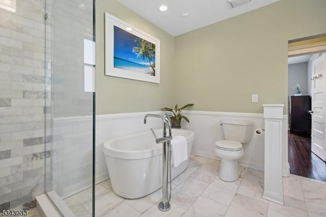22 Salter Pl, Maplewood Twp, NJ 07040 - bathroom featuring marble look tile flooring, a shower stall, a soaking tub, wainscoting, and toilet