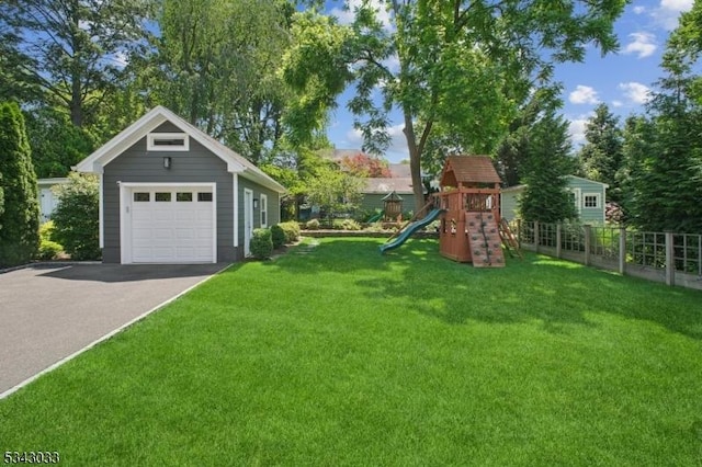 22 Salter Pl, Maplewood Twp, NJ 07040 - view of yard featuring a detached garage, a playground, driveway, and an outdoor structure