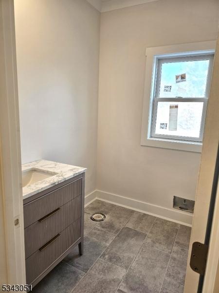 bathroom with vanity and baseboards