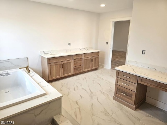 bathroom featuring baseboards, recessed lighting, a bath, marble finish floor, and a sink