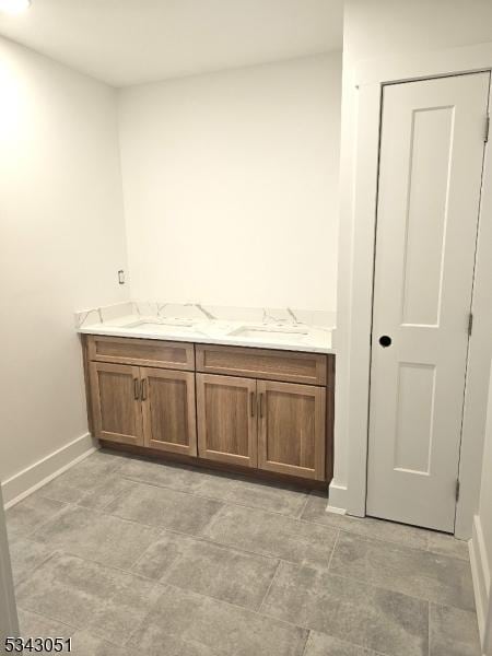 bathroom featuring a sink and baseboards