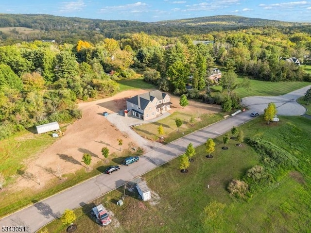 birds eye view of property featuring a wooded view