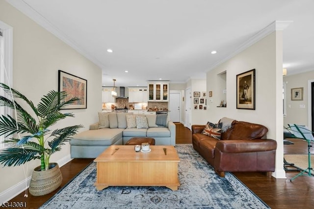 living room with crown molding, baseboards, and wood finished floors