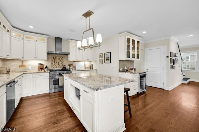 kitchen with beverage cooler, stainless steel appliances, white cabinetry, wall chimney exhaust hood, and dark wood-style flooring