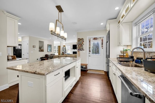 kitchen with stainless steel dishwasher, dark wood-type flooring, crown molding, and a sink