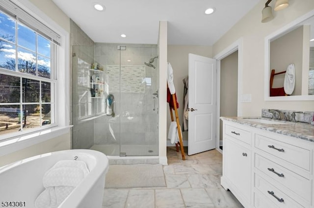 bathroom with a freestanding bath, marble finish floor, a stall shower, and vanity