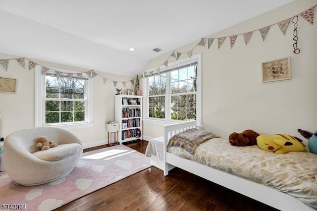 bedroom featuring baseboards, multiple windows, lofted ceiling, and wood finished floors