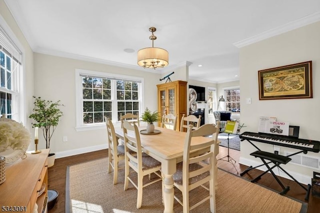 dining space featuring wood finished floors, recessed lighting, a fireplace, crown molding, and baseboards