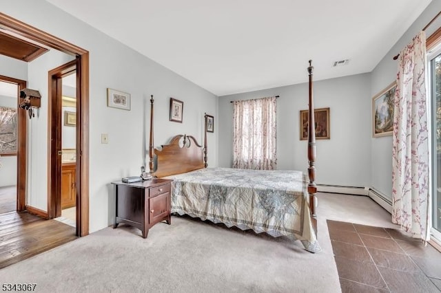 bedroom featuring visible vents, carpet floors, and a baseboard radiator