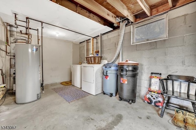 unfinished basement featuring gas water heater, concrete block wall, and independent washer and dryer