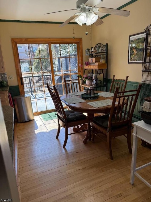 dining room with a ceiling fan and light wood-style floors