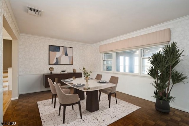 dining room featuring wallpapered walls, visible vents, and ornamental molding