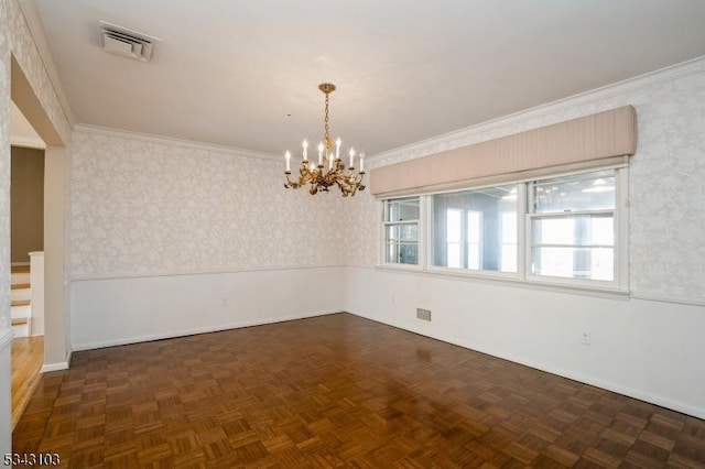 spare room with visible vents, an inviting chandelier, ornamental molding, and wallpapered walls