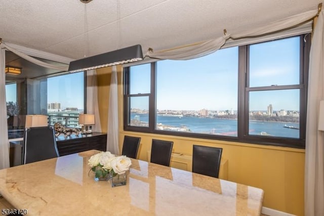 dining space featuring a city view and a textured ceiling