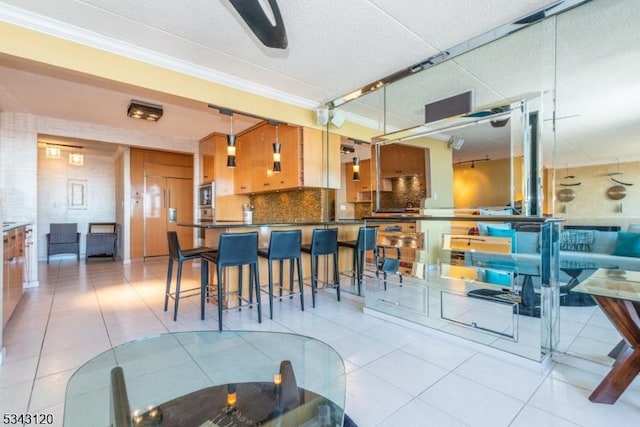 kitchen with decorative backsplash, dark countertops, light tile patterned flooring, and crown molding