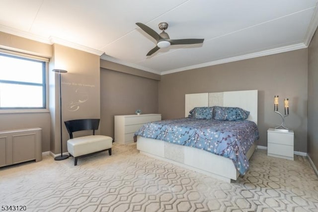 carpeted bedroom with a ceiling fan, baseboards, and ornamental molding