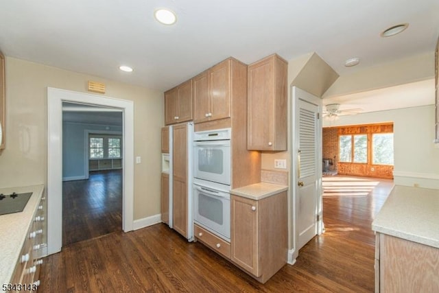 kitchen with a healthy amount of sunlight, white double oven, and dark wood-type flooring