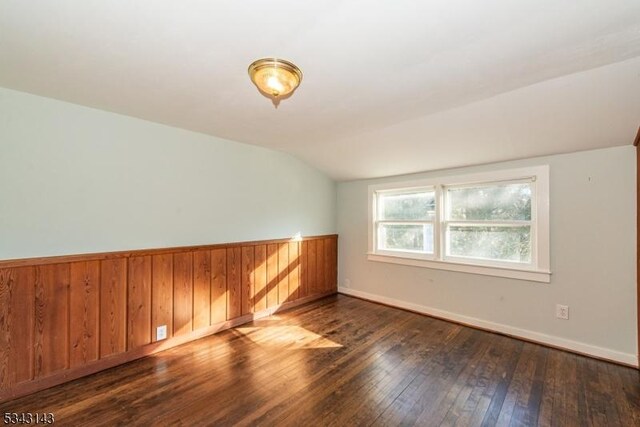 bonus room featuring baseboards, lofted ceiling, and hardwood / wood-style flooring