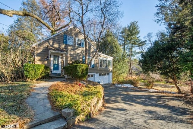 view of front of house featuring aphalt driveway and an attached garage