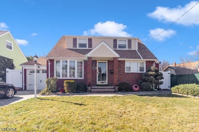 view of front of house featuring aphalt driveway, a garage, brick siding, and a front yard