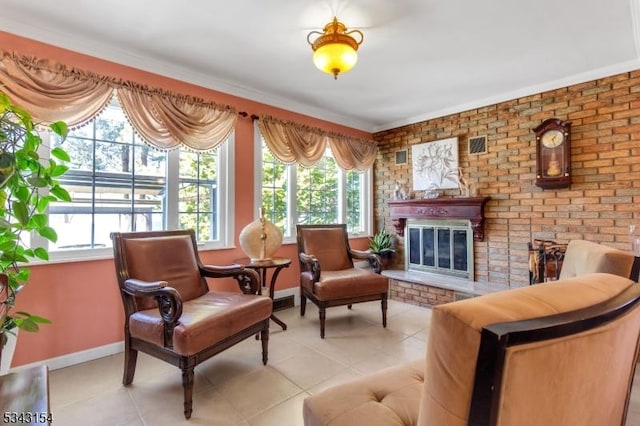 sitting room with a wealth of natural light, baseboards, a brick fireplace, and light tile patterned floors