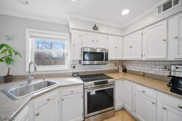 kitchen with a sink, visible vents, tasteful backsplash, and appliances with stainless steel finishes