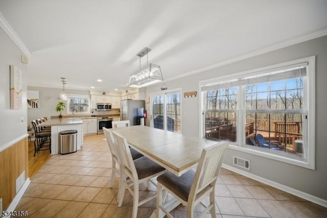 dining space featuring light tile patterned floors, visible vents, and ornamental molding