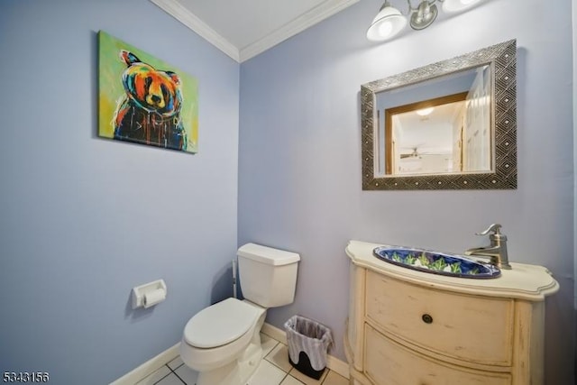 bathroom featuring tile patterned floors, toilet, crown molding, and baseboards