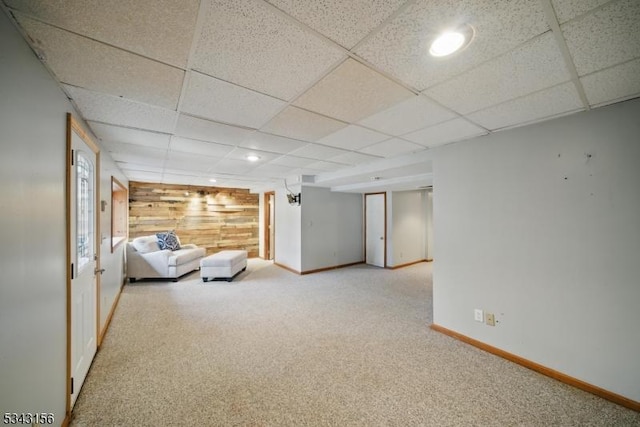 unfurnished room featuring baseboards, recessed lighting, a paneled ceiling, wood walls, and carpet flooring