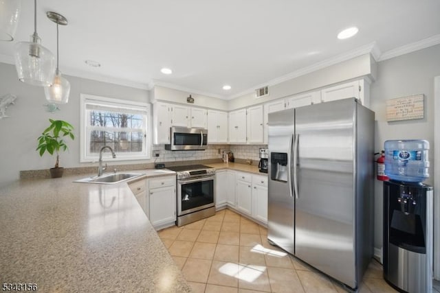 kitchen featuring visible vents, backsplash, stainless steel appliances, white cabinetry, and a sink