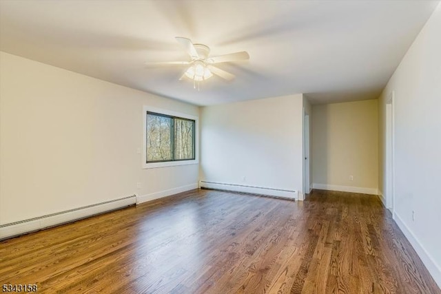 empty room featuring ceiling fan, baseboards, baseboard heating, and wood finished floors