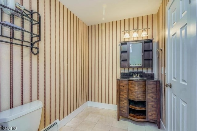 half bathroom featuring tile patterned flooring, wallpapered walls, baseboards, toilet, and vanity