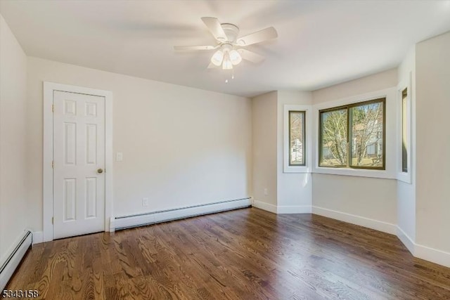 spare room featuring a baseboard heating unit, baseboards, baseboard heating, wood finished floors, and a ceiling fan