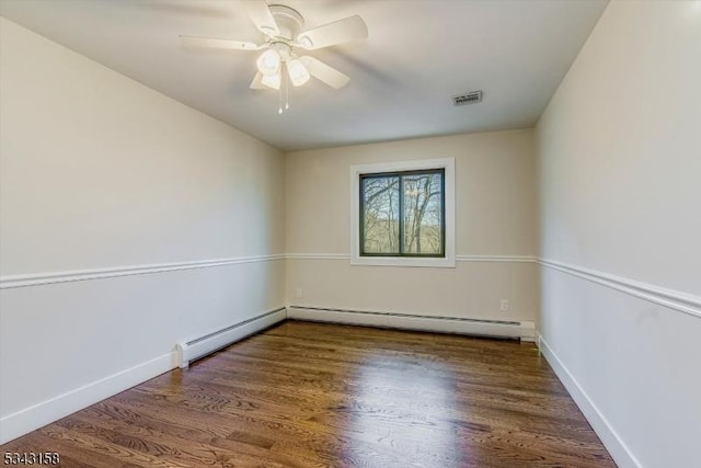 empty room with visible vents, a baseboard heating unit, baseboards, ceiling fan, and wood finished floors