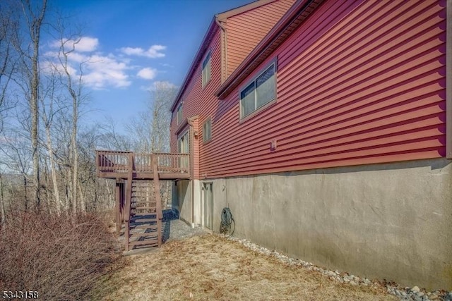 view of home's exterior featuring stairs and a deck