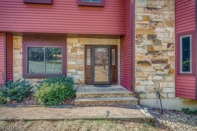 doorway to property featuring stone siding