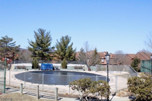 view of community with fence