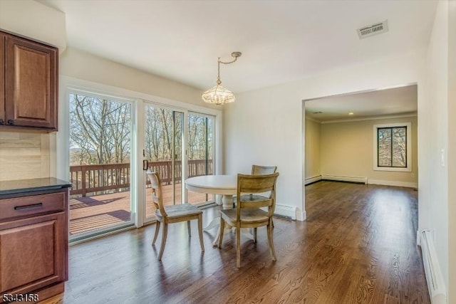 dining area featuring dark wood-style floors, visible vents, baseboards, and a baseboard radiator