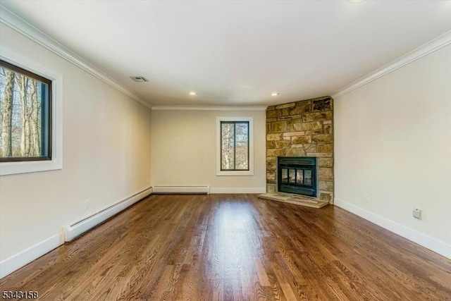 unfurnished living room featuring crown molding, wood finished floors, baseboards, and baseboard heating