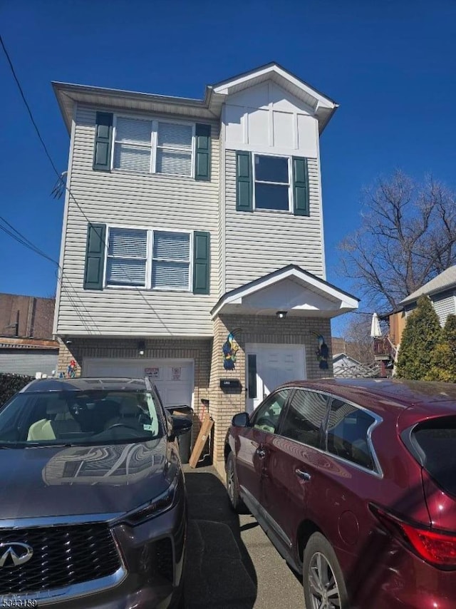 view of front of house featuring brick siding and an attached garage