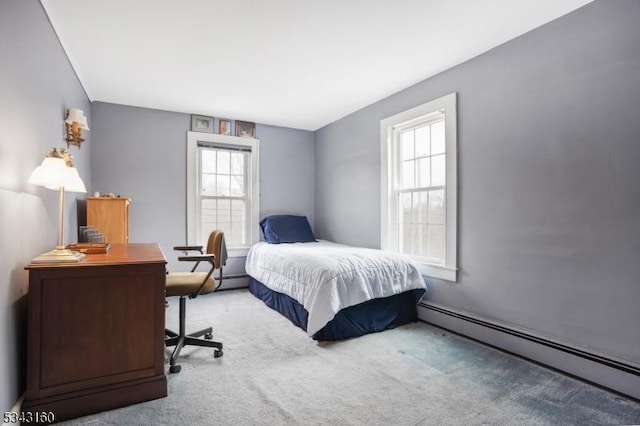 bedroom with carpet and a baseboard radiator