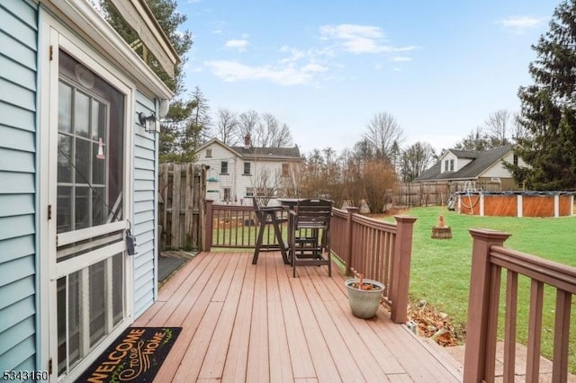 deck featuring a yard and fence