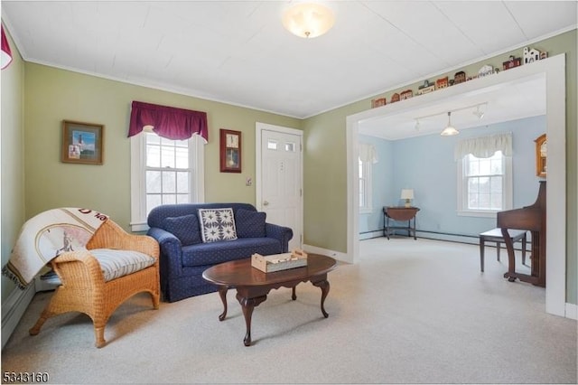 carpeted living room featuring a baseboard heating unit, baseboards, and ornamental molding