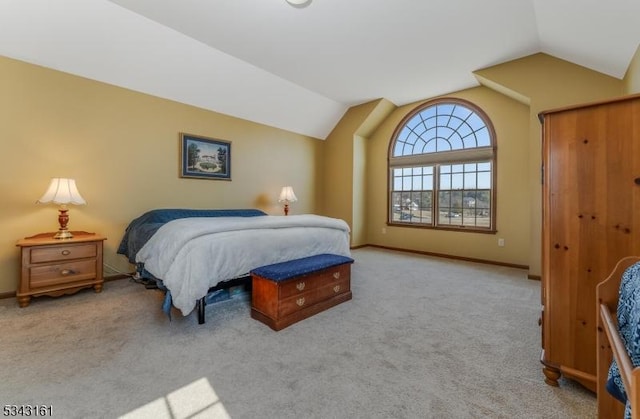 bedroom with baseboards, carpet floors, and vaulted ceiling