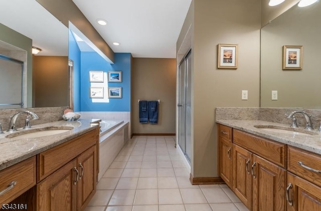 full bath featuring tile patterned floors, two vanities, a shower stall, and a sink