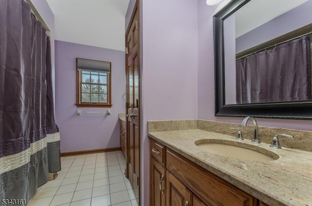 full bath featuring tile patterned floors, vanity, and baseboards