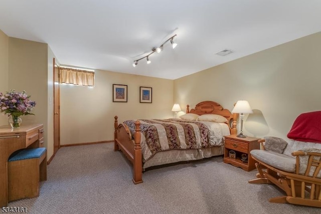 bedroom with visible vents, light carpet, baseboards, and track lighting